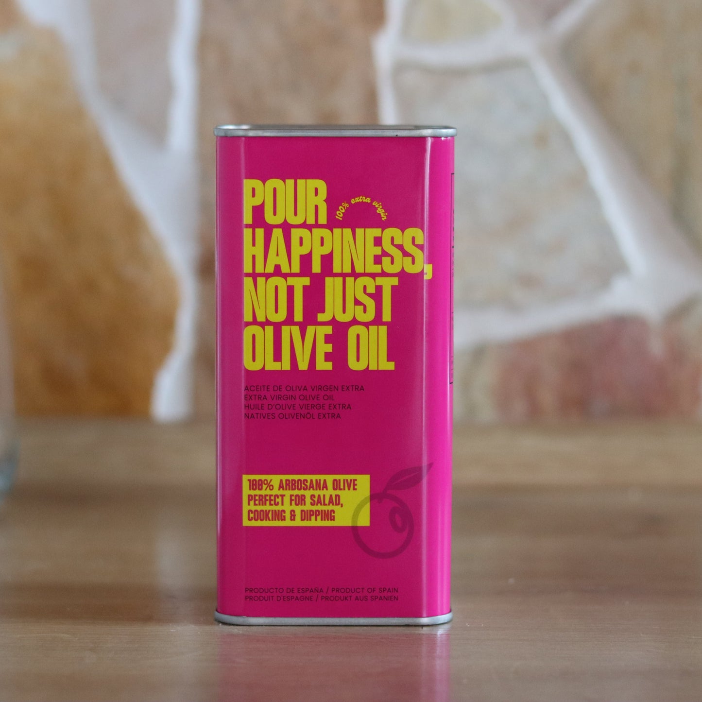 Pour Happiness olive oil bottle labeled The Daily Drizzle, clear glass container with golden olive oil and black cap.
