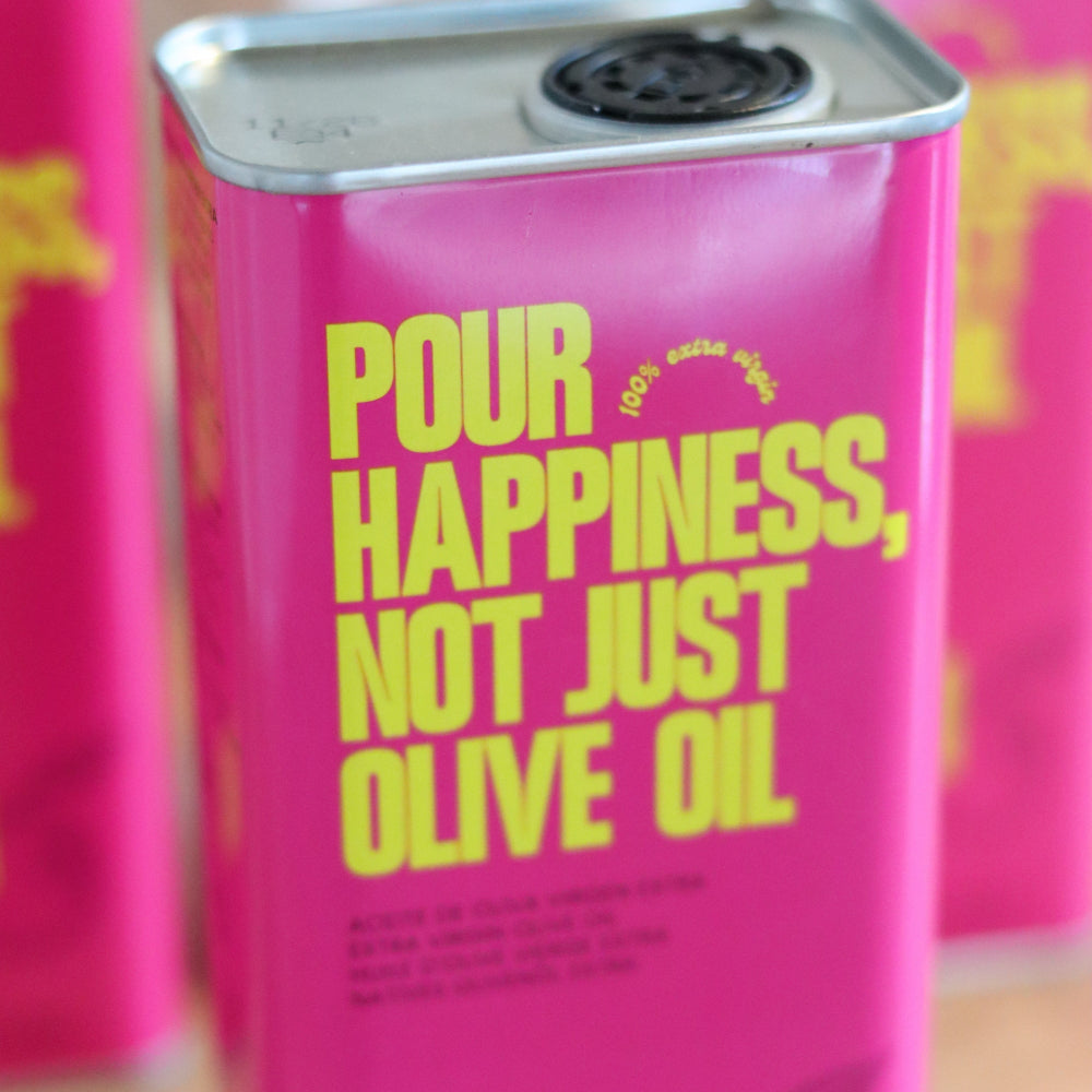 Six bottles of POUR HAPPINESS Family The Daily Drizzle olive oil with dark glass bottles and pour spouts.